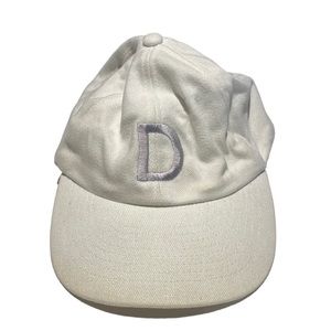 White baseball hat with silver “D” embroidered on front
